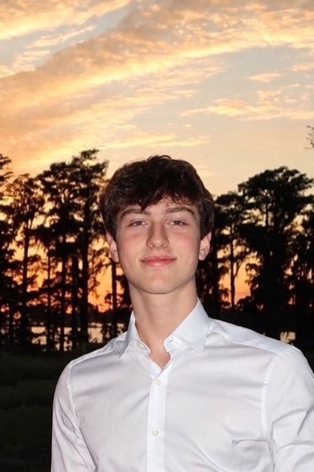 João Ferla, founder of CoinnectHub, smiling outdoors at sunset